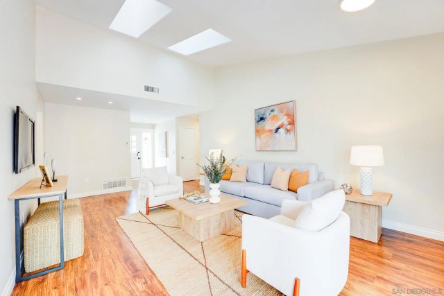 a living room with lots of furniture and a flat screen tv