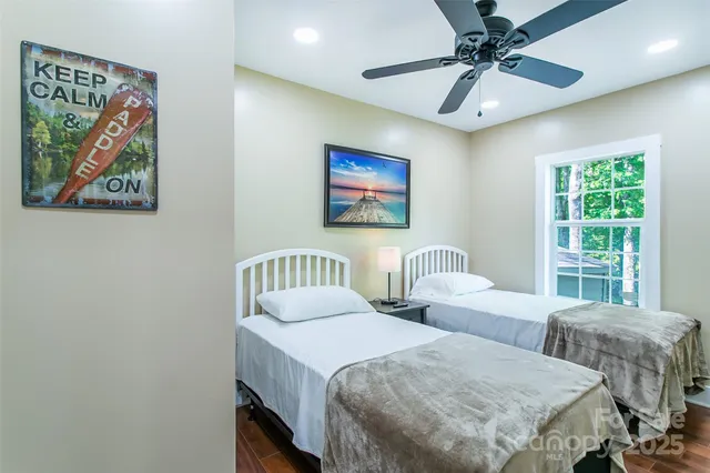 a bedroom with two beds and a window