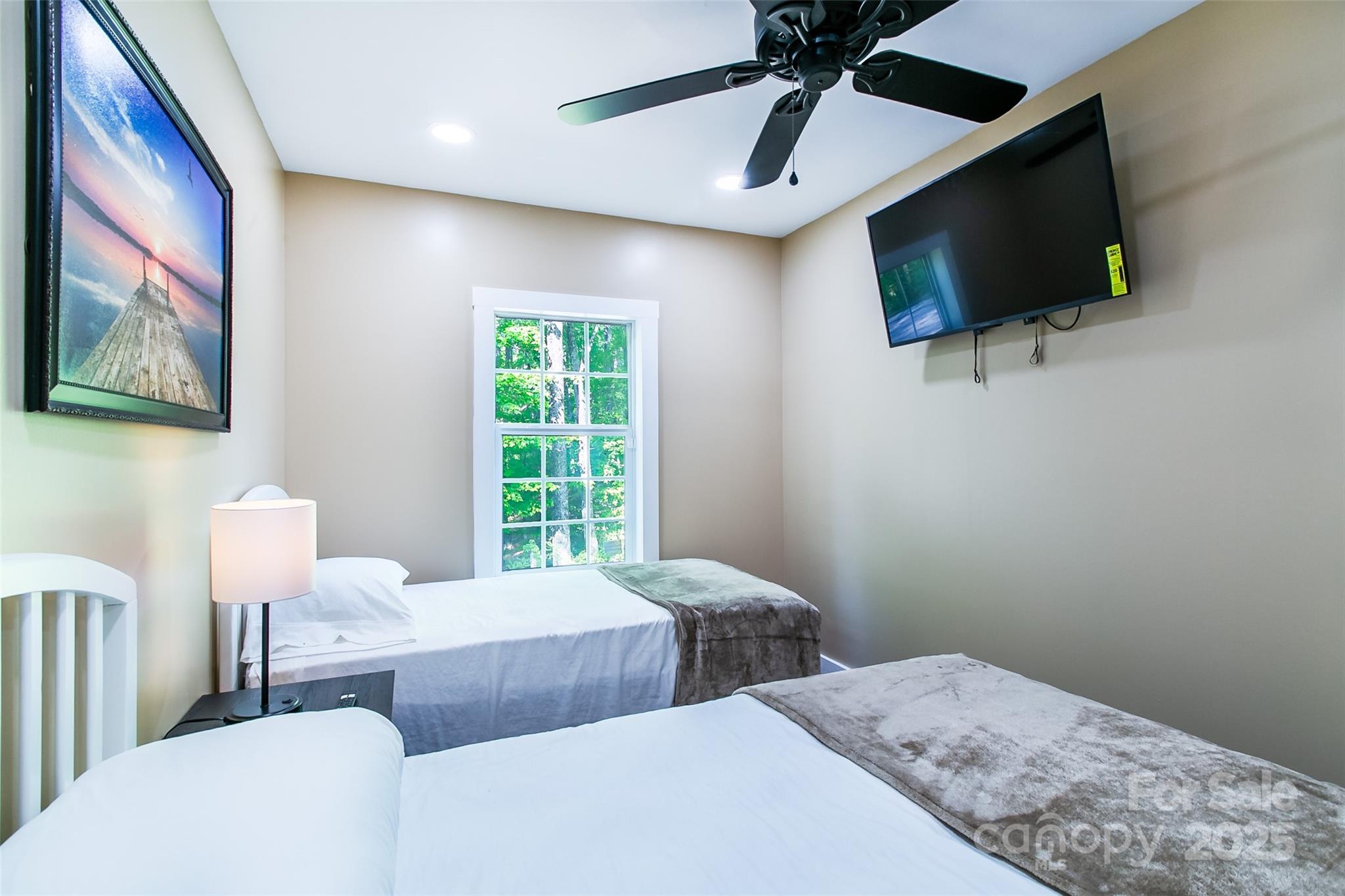 115 Cold Springs Drive Mill Spring, NC 28756 - Photo 18 of 42 a bedroom with two beds and a flat screen tv