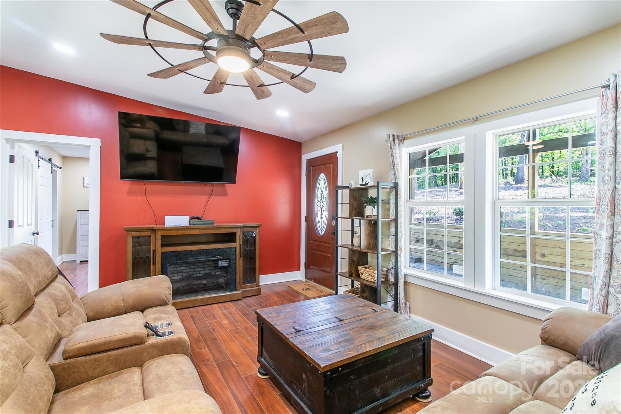 115 Cold Springs Drive Mill Spring, NC 28756 - Photo 20 of 42 a living room with furniture a flat screen tv and a chandelier