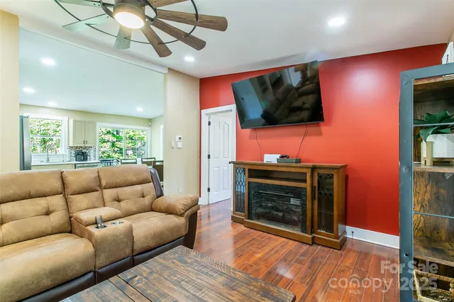 a living room with furniture a flat screen tv and a fireplace