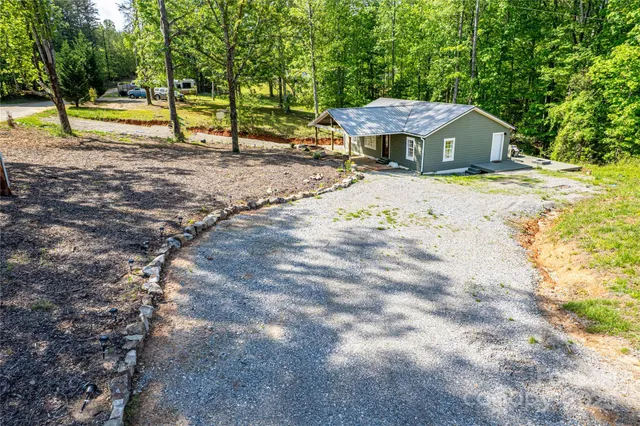 a view of a house with a yard and sitting area