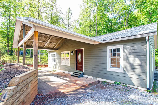 a backyard of a house with barbeque oven