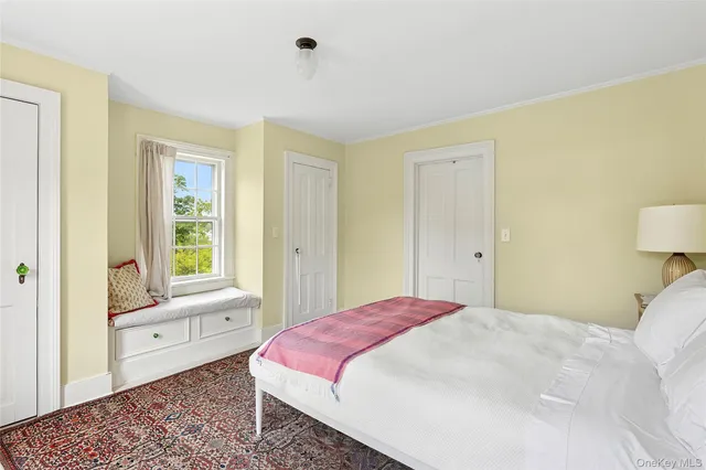 a bathroom with a sink a bathtub and next to a window