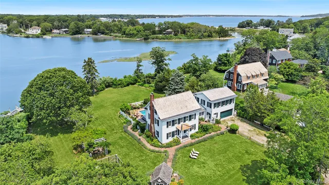an aerial view of a house with outdoor space and lake view