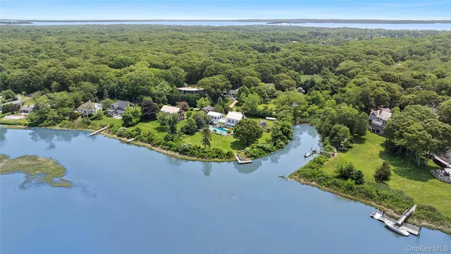 a view of a lake with couches chairs