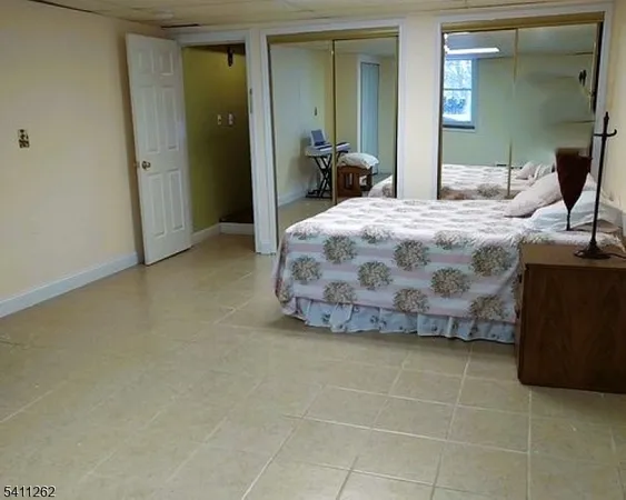 a bedroom with a bed and a mirror