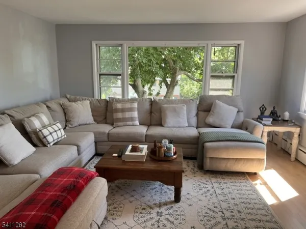 a living room with furniture and a large window