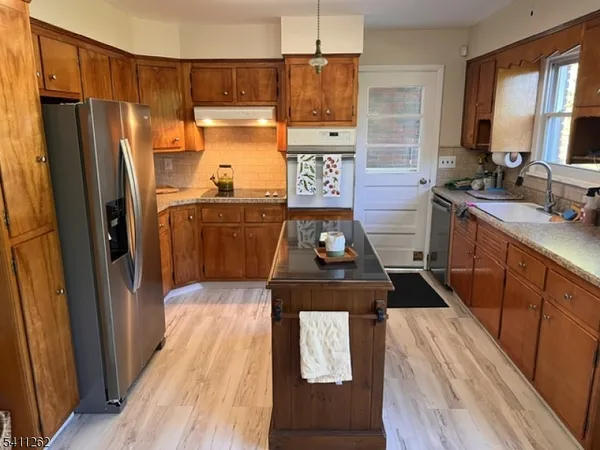 a kitchen with a refrigerator stove and sink