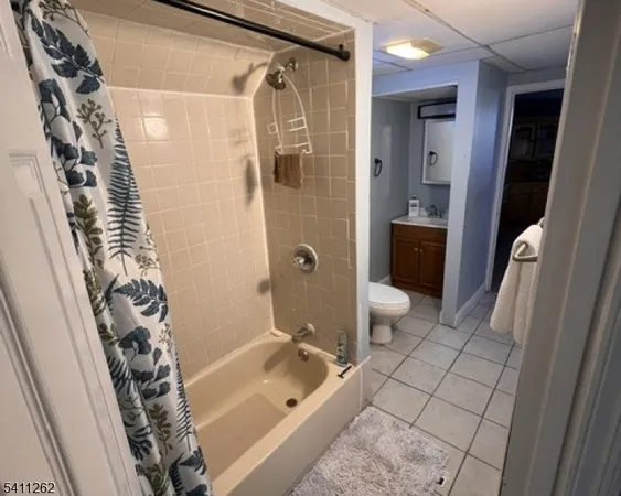a bathroom with a sink a toilet a shower and a mirror