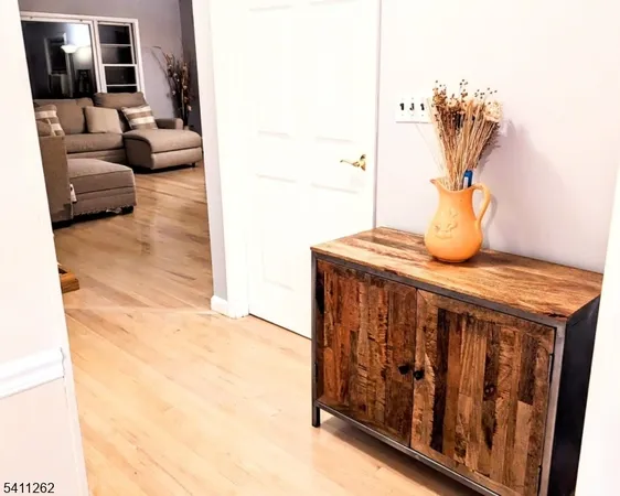 a view of living room with furniture and mirror