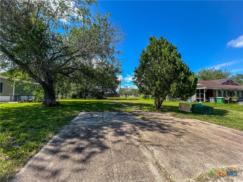 3112 East Rio Grande Street Victoria, TX 77901 - Photo 2 of 2 a view of a house with a big yard and large trees