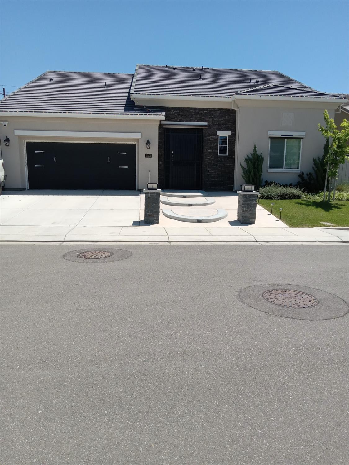 a front view of a house with a yard