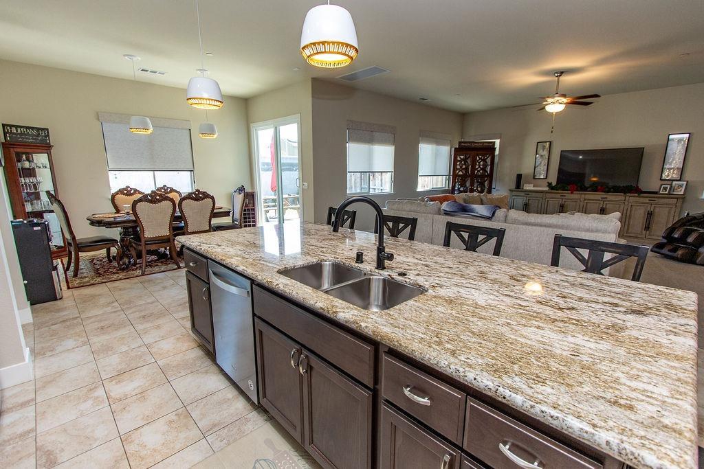 2354 Ruthie Place Manteca, CA 95337 - Photo 6 of 22 a large kitchen with granite countertop a sink and a counter top space