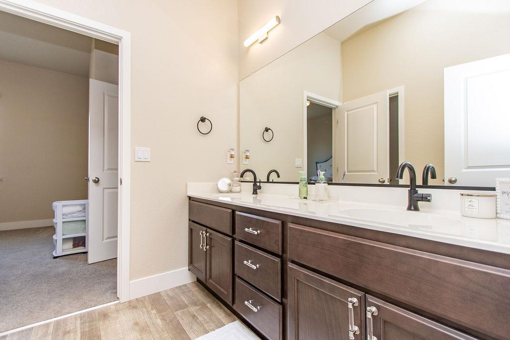 2354 Ruthie Place Manteca, CA 95337 - Photo 9 of 22 a bathroom with a double vanity sink mirror and toilet
