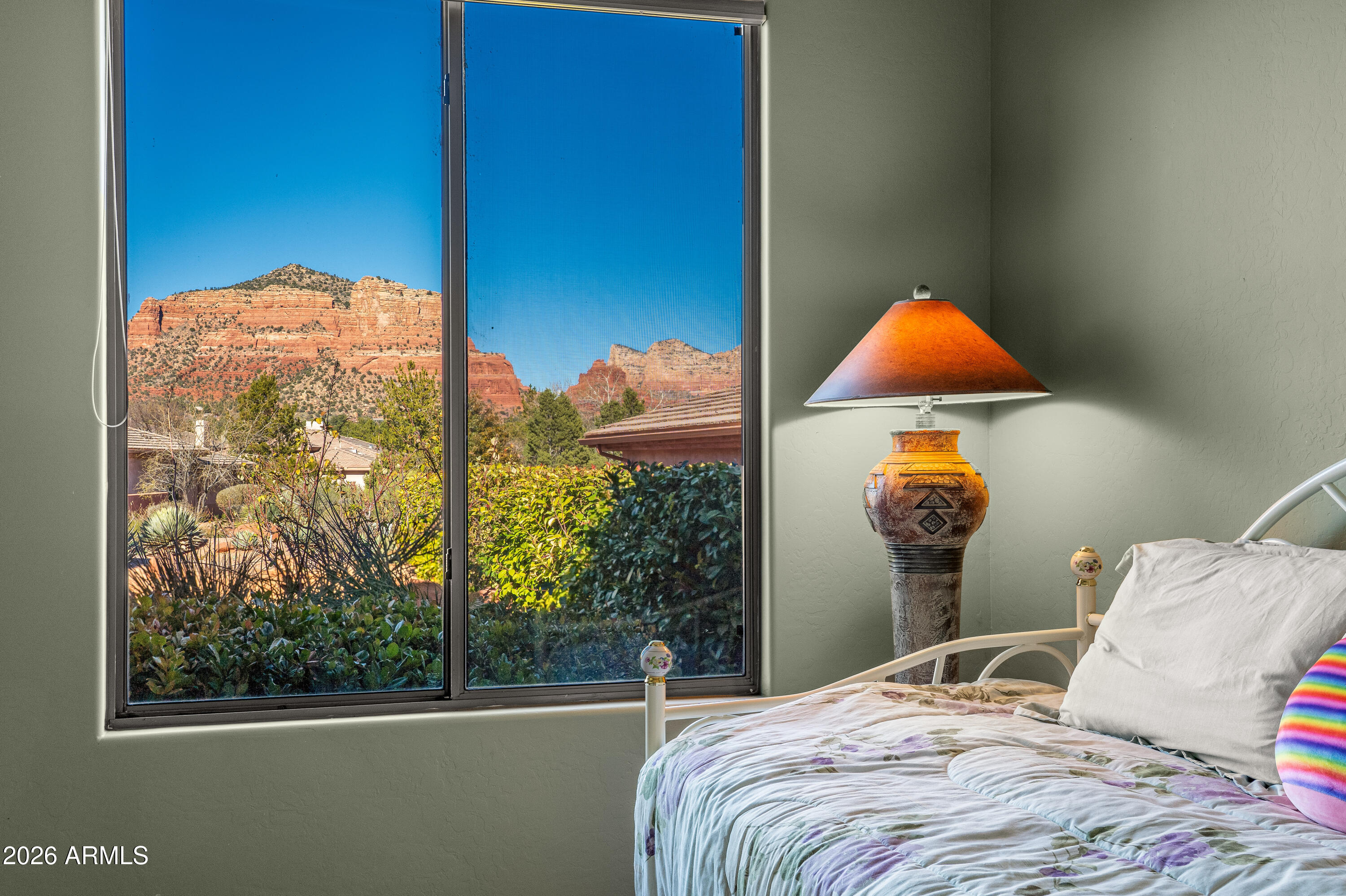 1070 Crown Ridge Road Sedona, AZ 86351 - Photo 18 of 28 a bedroom with a bed and a window