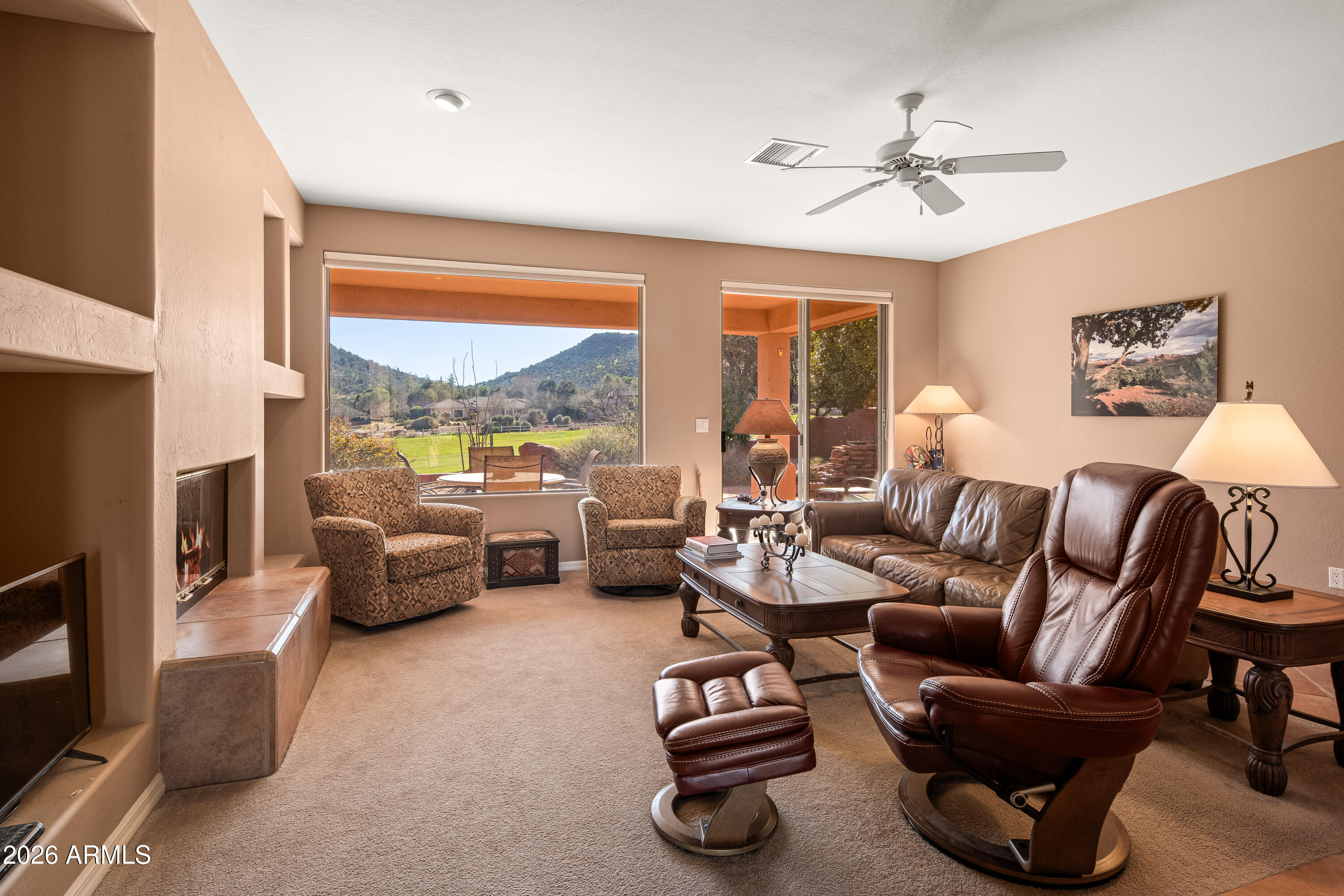 1070 Crown Ridge Road Sedona, AZ 86351 - Photo 4 of 28 a living room with furniture ceiling fan and a large window