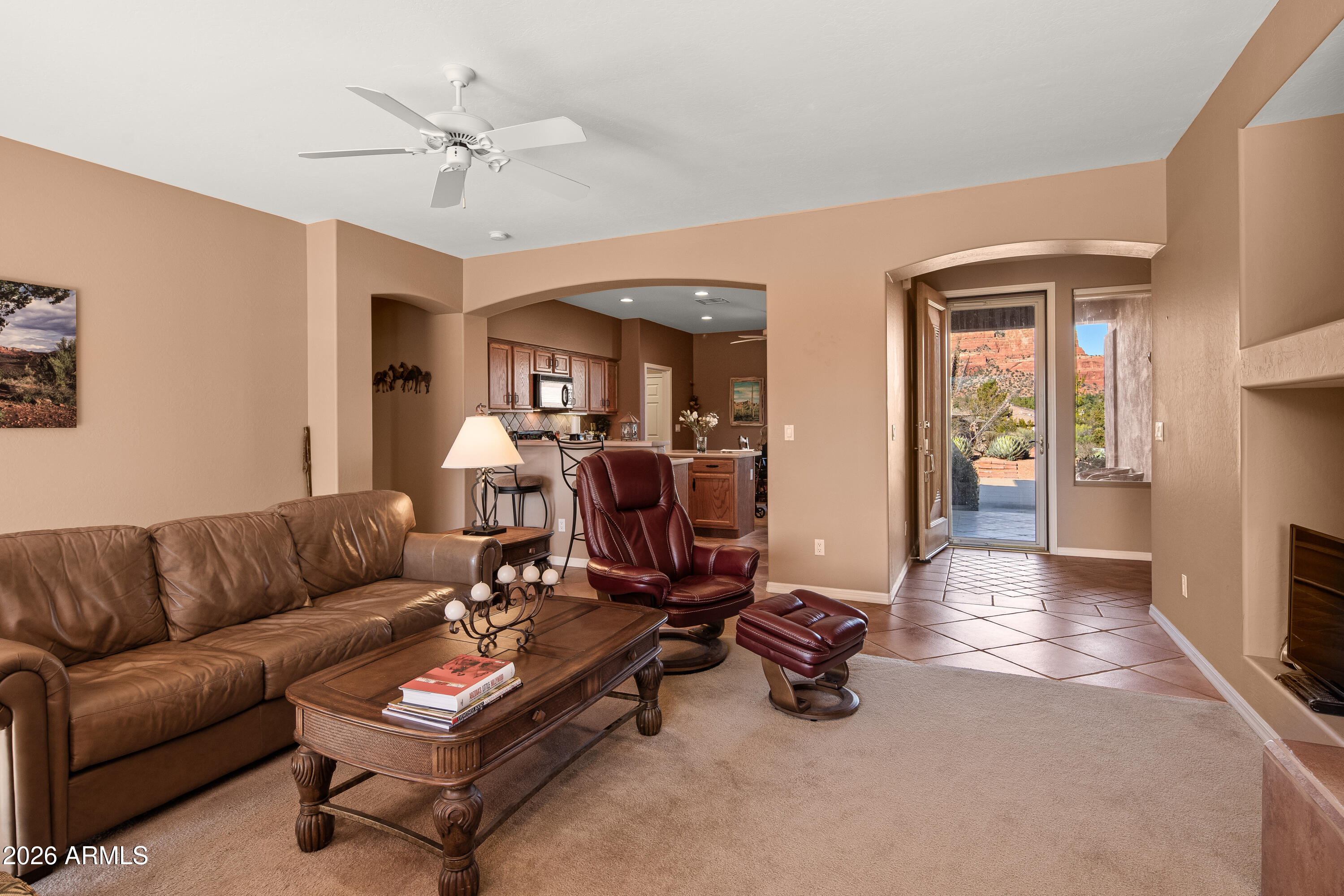 1070 Crown Ridge Road Sedona, AZ 86351 - Photo 7 of 28 a living room with furniture a rug and a chandelier