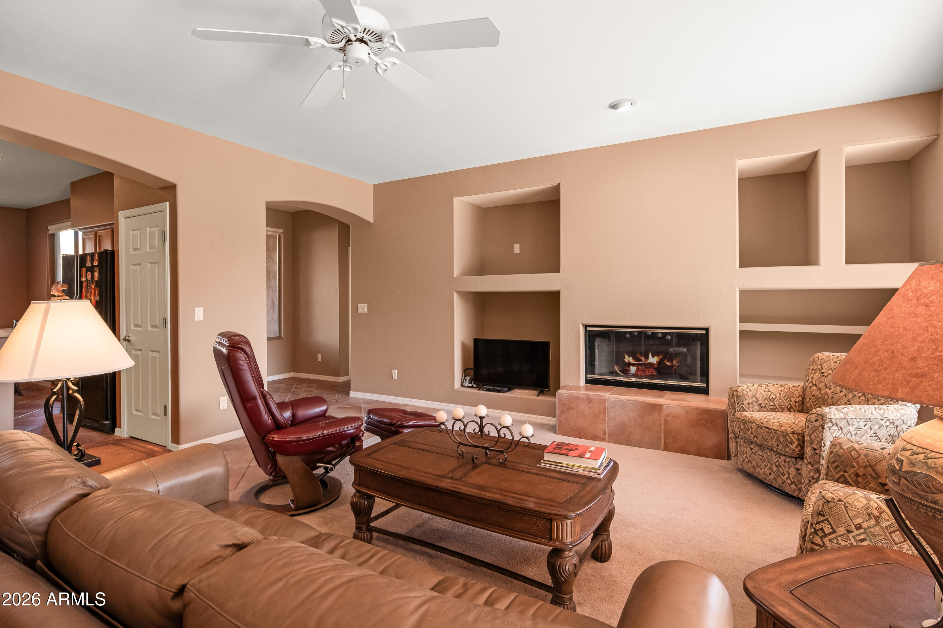 1070 Crown Ridge Road Sedona, AZ 86351 - Photo 8 of 28 a living room with furniture and a fireplace