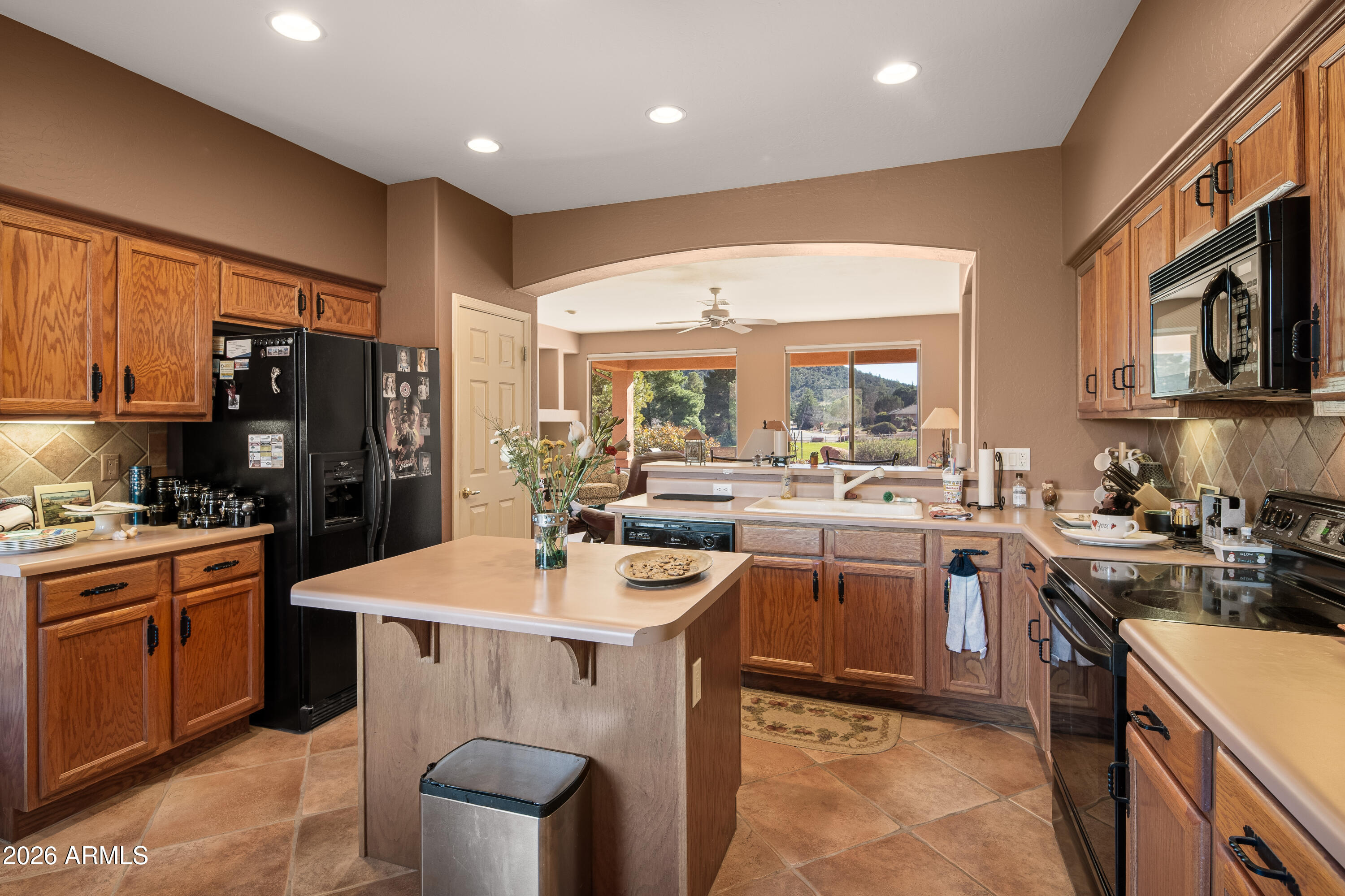 1070 Crown Ridge Road Sedona, AZ 86351 - Photo 10 of 28 a kitchen with sink a stove and chairs