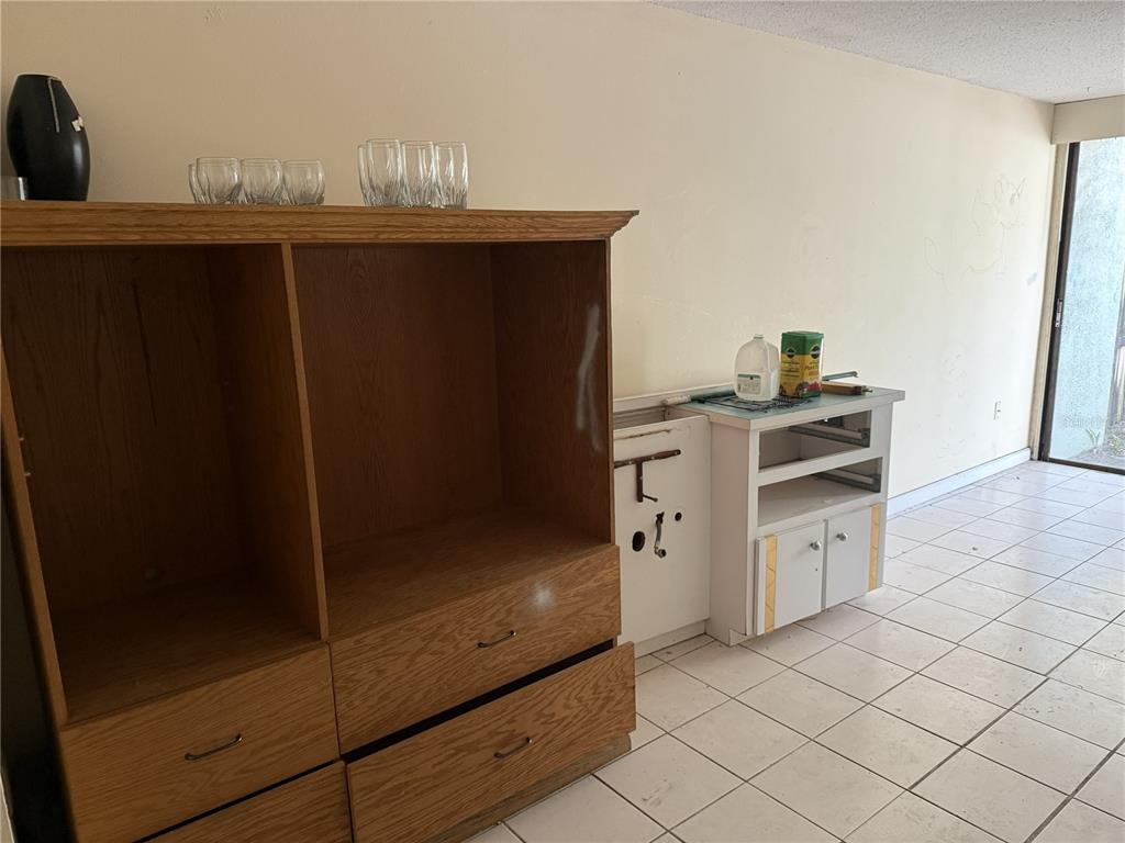 709 Southwest 75th Street, Unit 104 Gainesville, FL 32607 - Photo 12 of 34 a kitchen with a sink and cabinets