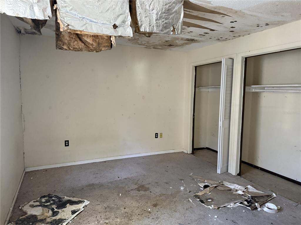 709 Southwest 75th Street, Unit 104 Gainesville, FL 32607 - Photo 16 of 34 a room with water heater and wooden cabinet