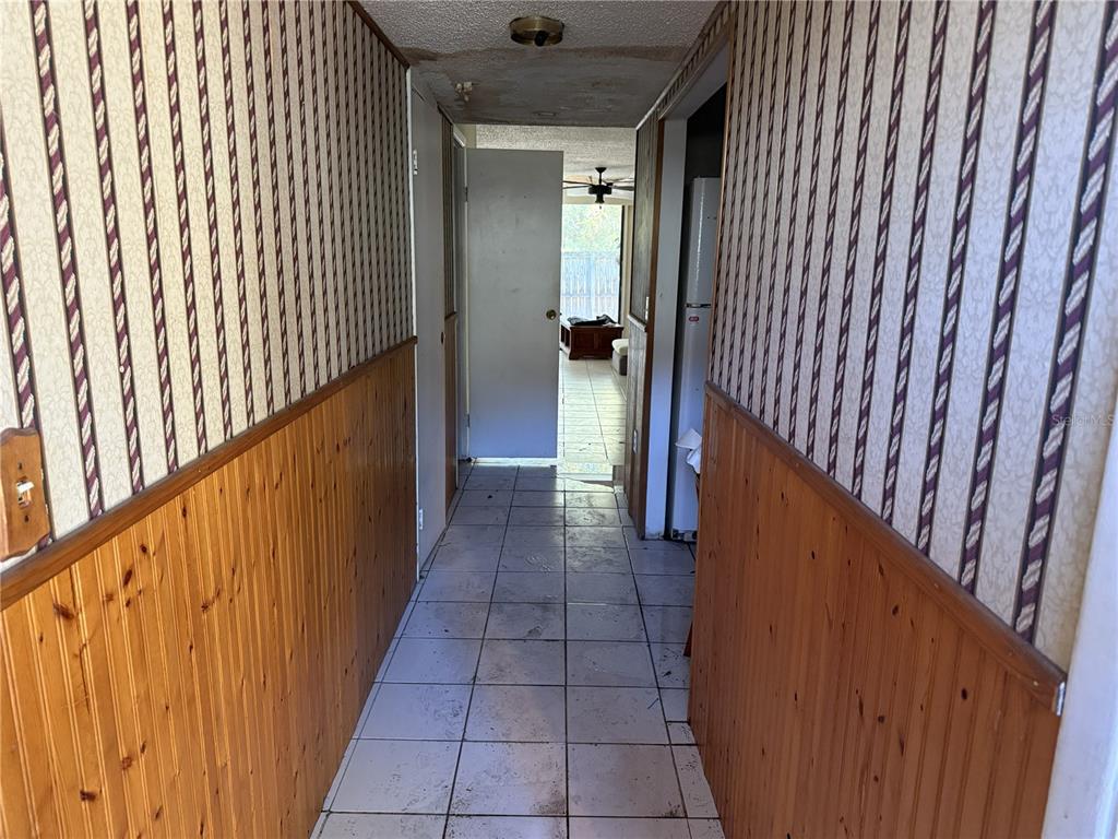 709 Southwest 75th Street, Unit 104 Gainesville, FL 32607 - Photo 2 of 34 a view of a hallway with wooden cabinets