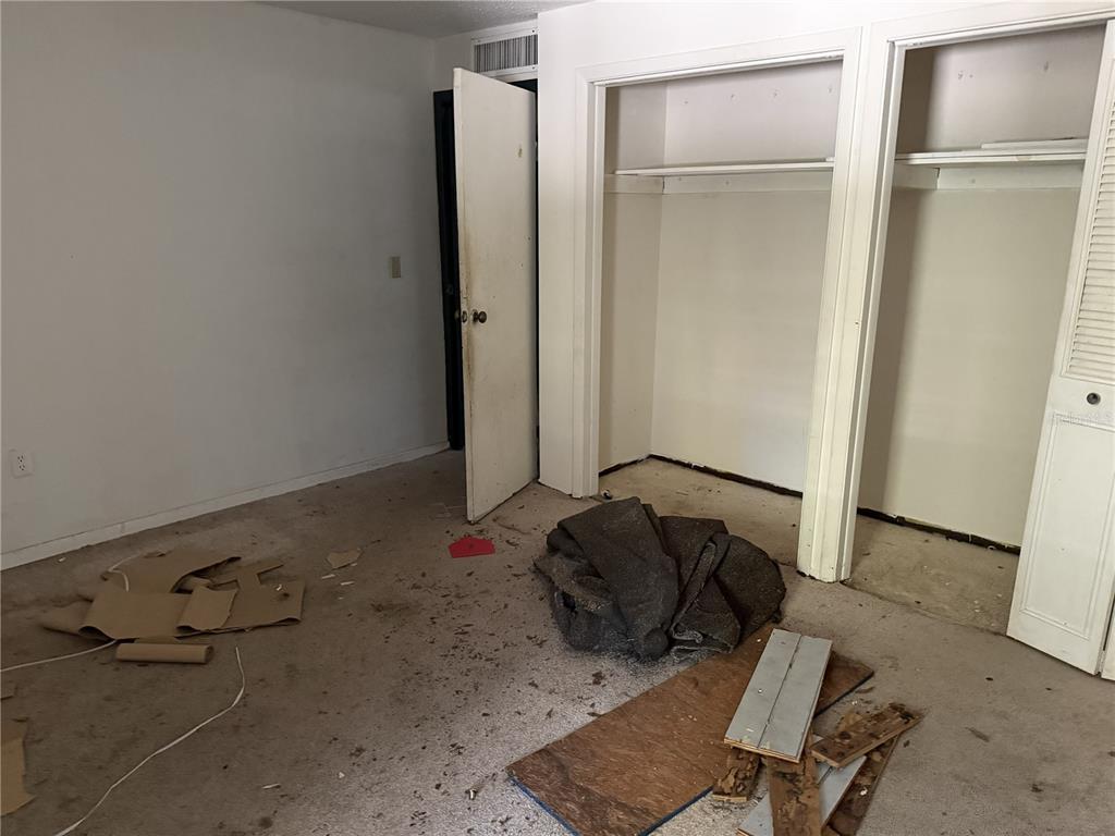 709 Southwest 75th Street, Unit 104 Gainesville, FL 32607 - Photo 24 of 34 a room with a bed and a refrigerator