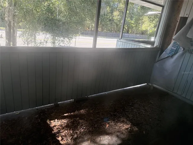 a bathroom with a granite countertop sink window and mirror