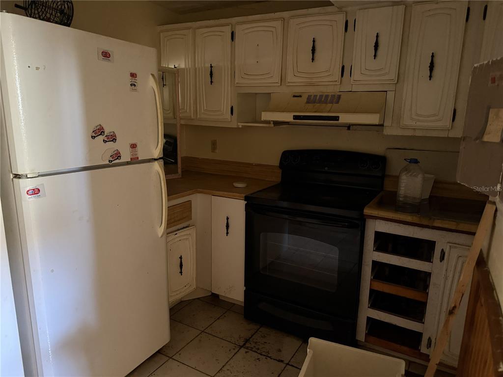 709 Southwest 75th Street, Unit 104 Gainesville, FL 32607 - Photo 3 of 34 a white refrigerator freezer and a stove sitting inside of a kitchen