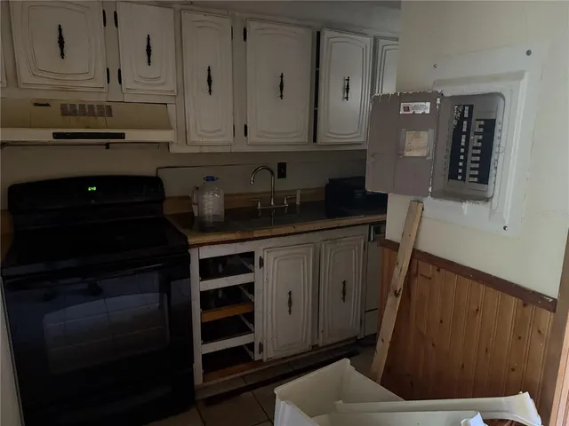 a kitchen with stainless steel appliances a cabinets and a stove top oven