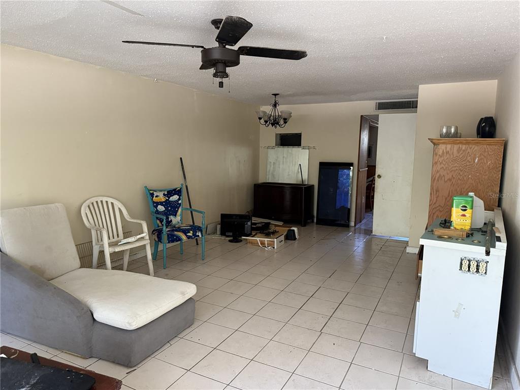 709 Southwest 75th Street, Unit 104 Gainesville, FL 32607 - Photo 9 of 34 a bedroom with furniture and a gym equipment