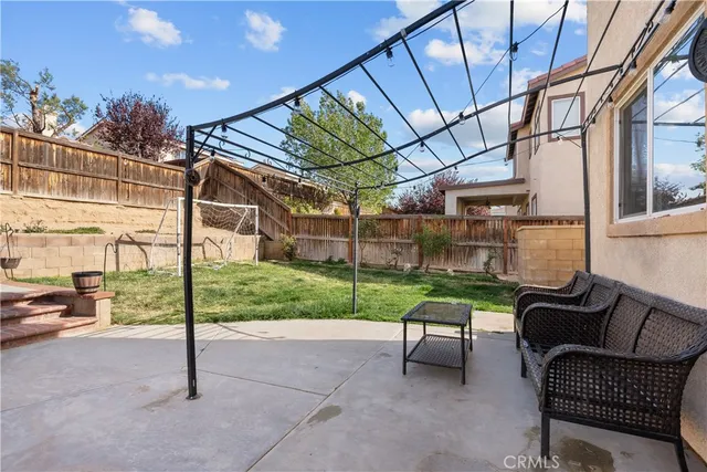 a view of a porch with furniture and a yard