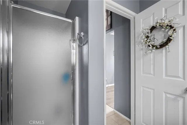 a bedroom with a bed a flat screen tv and a couch