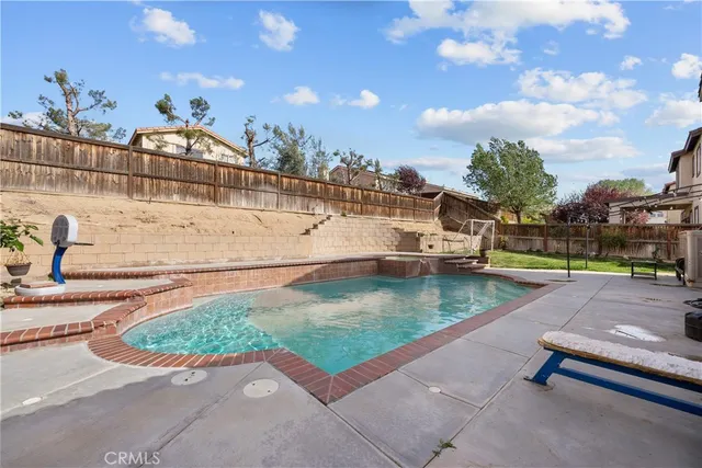 a view of a swimming pool with a lounge chairs