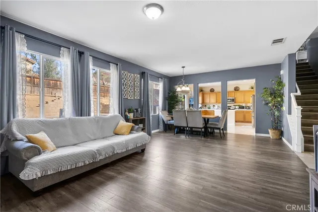 a living room with furniture and large windows