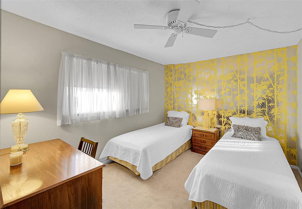 555 Northwest 4th Avenue, Unit 4190 Boca Raton, FL 33432 - Photo 11 of 18 a spacious bedroom with two beds and a lamp