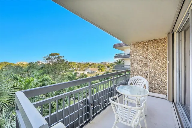 a view of a balcony with mountain view and wooden floor