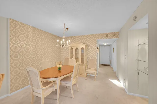 a dining room with furniture and chandelier kitchen view