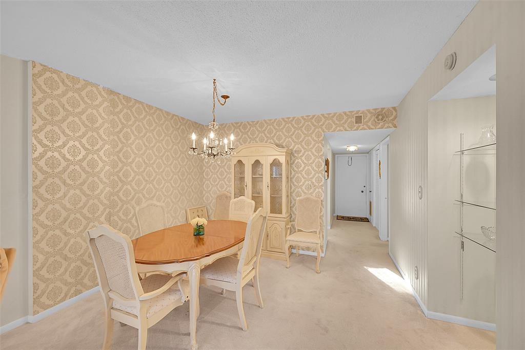 555 Northwest 4th Avenue, Unit 4190 Boca Raton, FL 33432 - Photo 5 of 18 a dining room with furniture and chandelier kitchen view