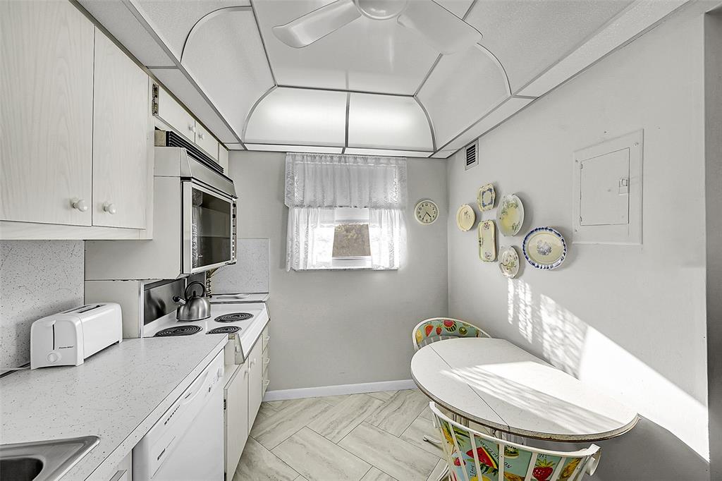 555 Northwest 4th Avenue, Unit 4190 Boca Raton, FL 33432 - Photo 7 of 18 a bathroom with a sink a toilet and mirror