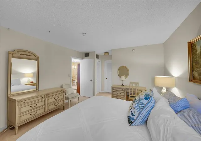 a bedroom with a bed and a mirror