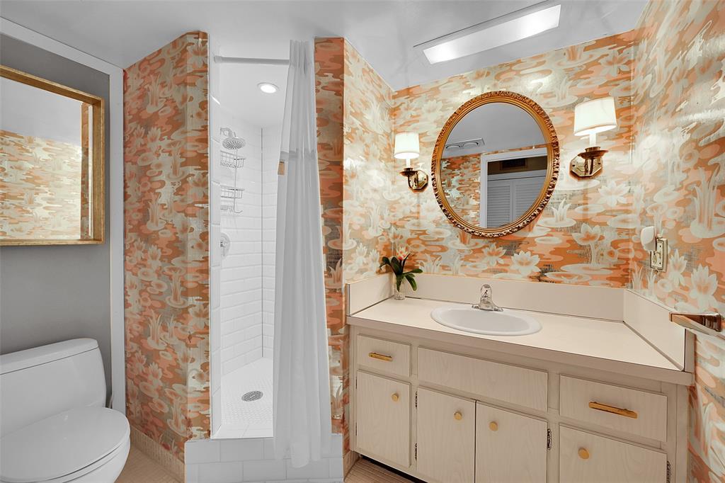 555 Northwest 4th Avenue, Unit 4190 Boca Raton, FL 33432 - Photo 10 of 18 a bathroom with a sink a mirror a toilet and a shower