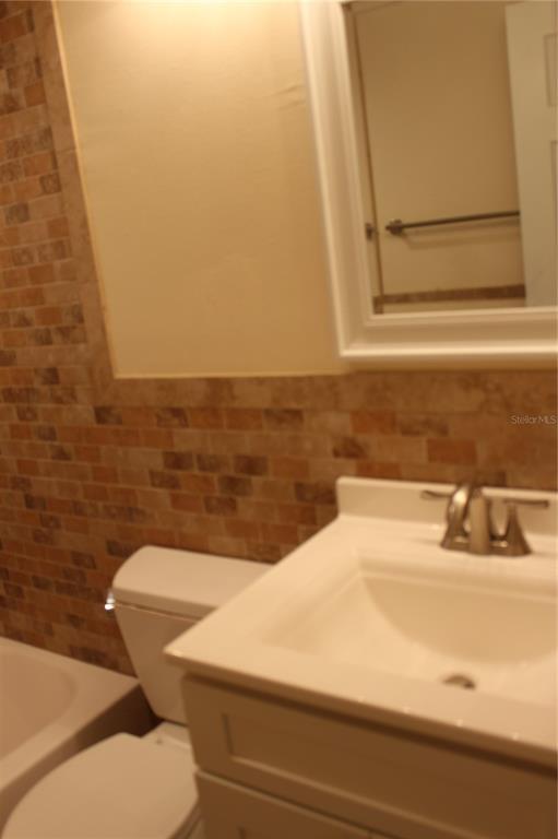 6812 Roosevelt Drive Port Richey, FL 34668 - Photo 8 of 11 a bathroom with a sink and a vanity