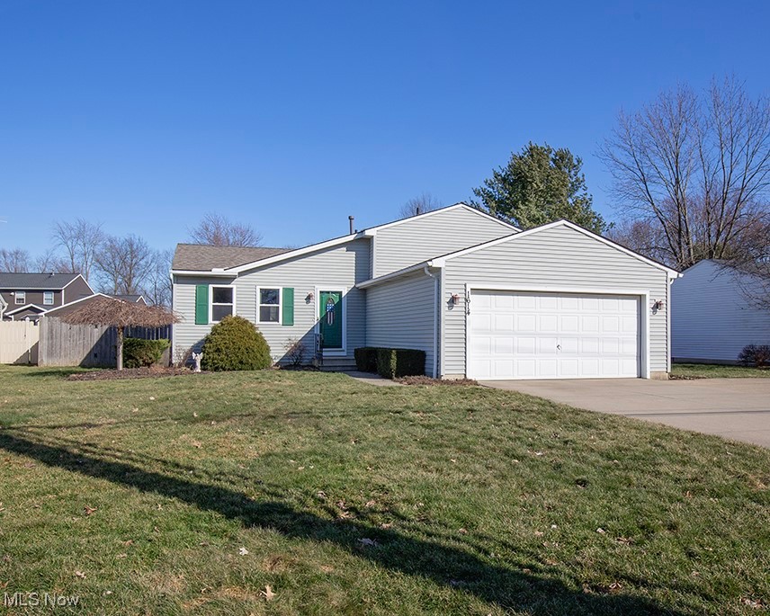 1614 South Abbe Road Elyria, OH 44035 - Photo 1 of 35 View of front of property featuring fence, driveway, entry steps, a front lawn, and a garage