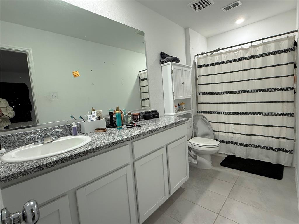 330 Ashbrook Way Princeton, TX 75407 - Photo 7 of 11 a bathroom with a granite countertop sink and a mirror