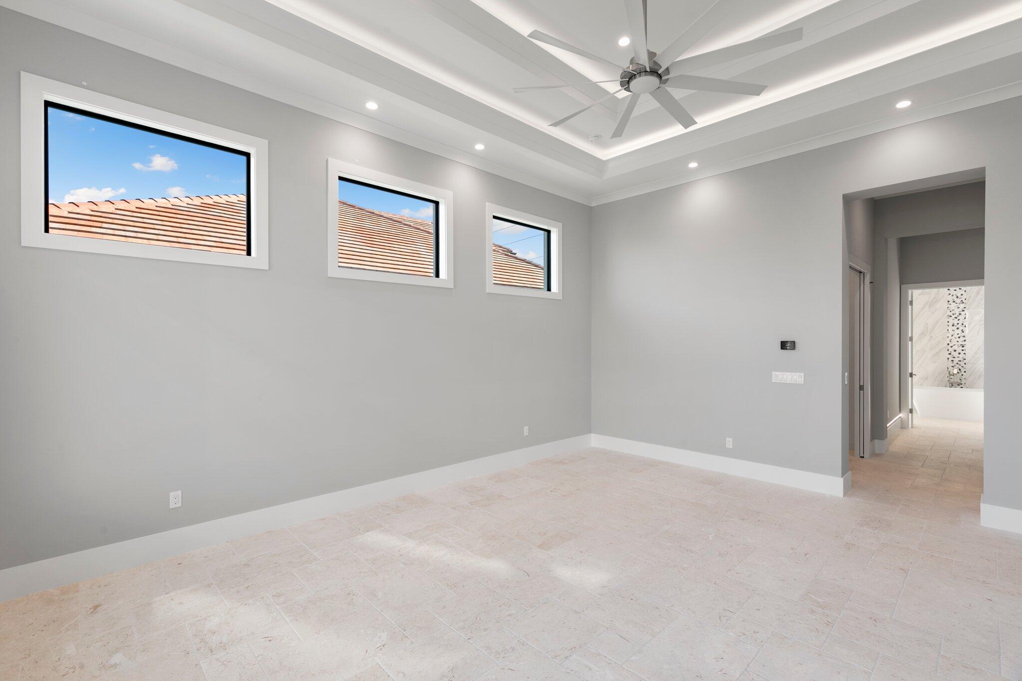 1960 San Marco Road Marco Island, FL 34145 - Photo 28 of 66 an empty room with windows and ceiling fan