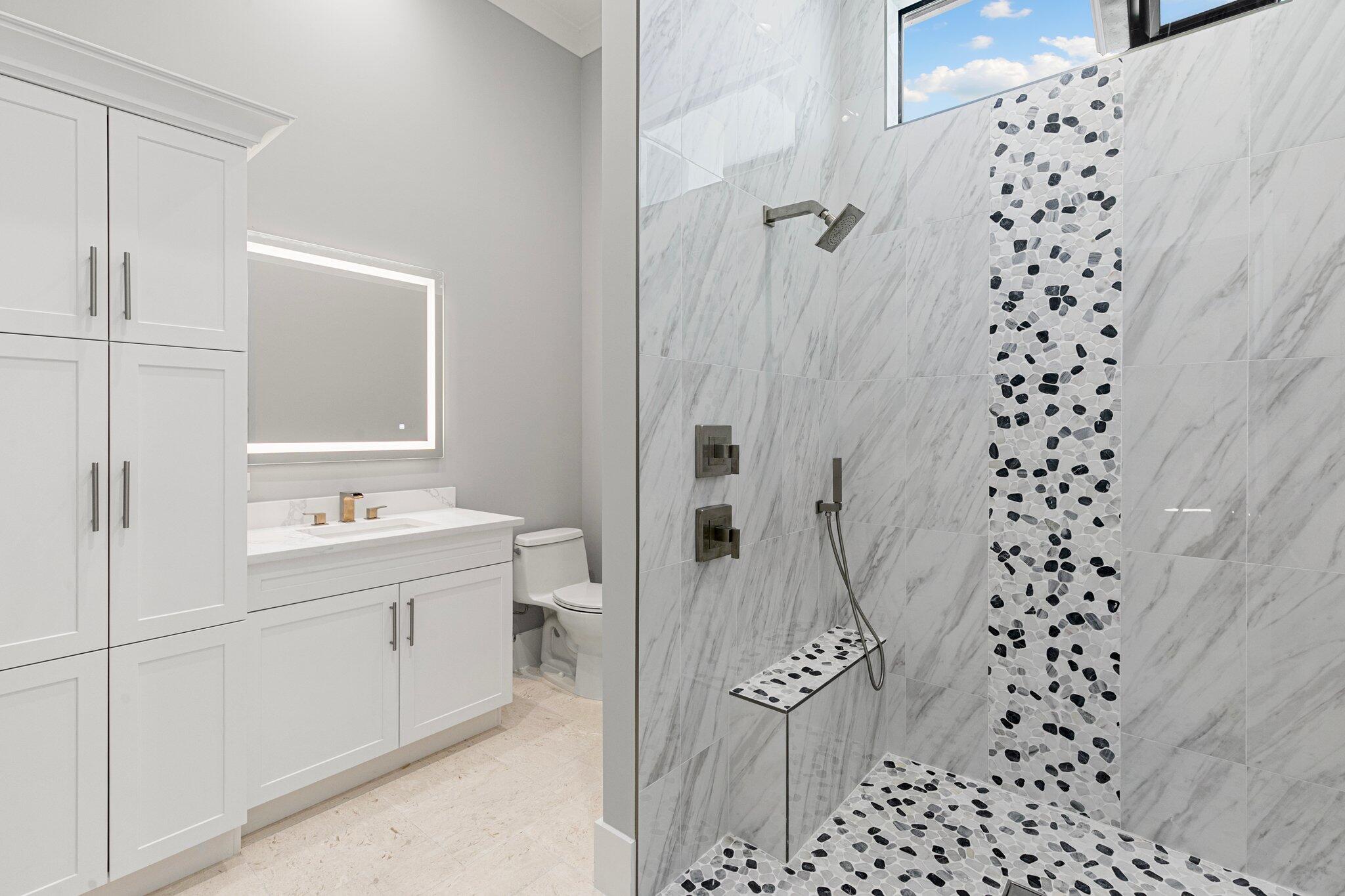 1960 San Marco Road Marco Island, FL 34145 - Photo 45 of 66 a bathroom with a sink a toilet and shower