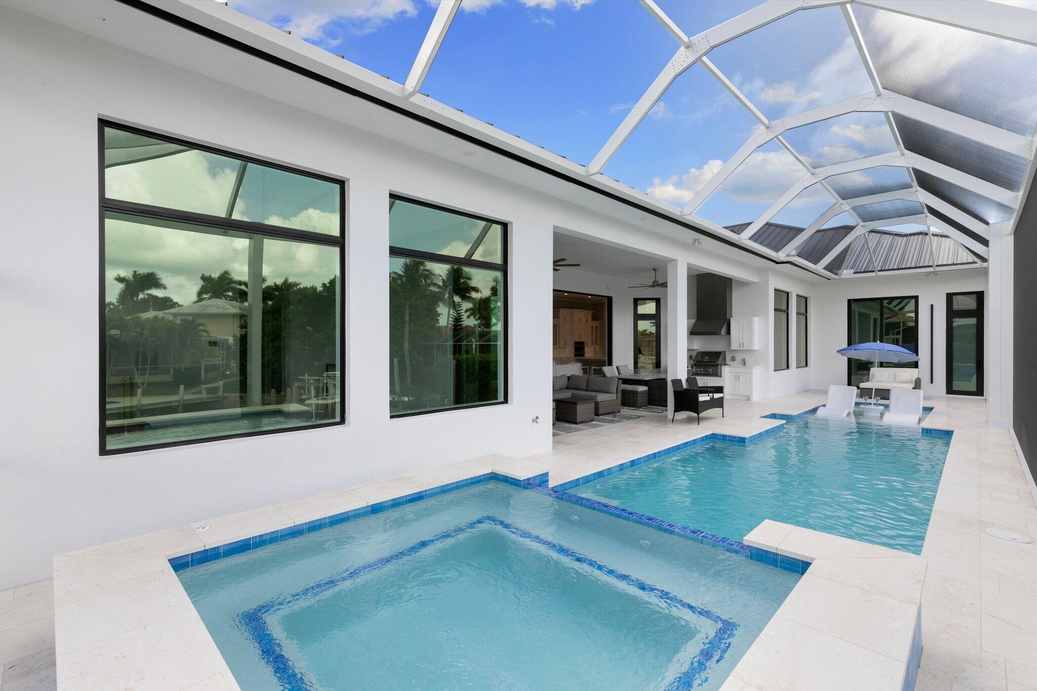 1960 San Marco Road Marco Island, FL 34145 - Photo 52 of 66 a view of a house with a backyard porch and sitting area