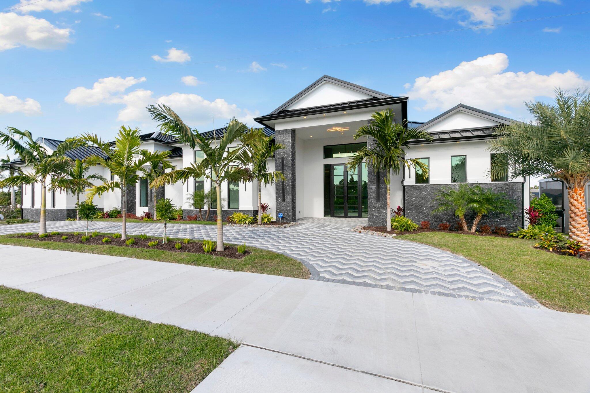 1960 San Marco Road Marco Island, FL 34145 - Photo 61 of 66 a view of a house with palm trees and a yard